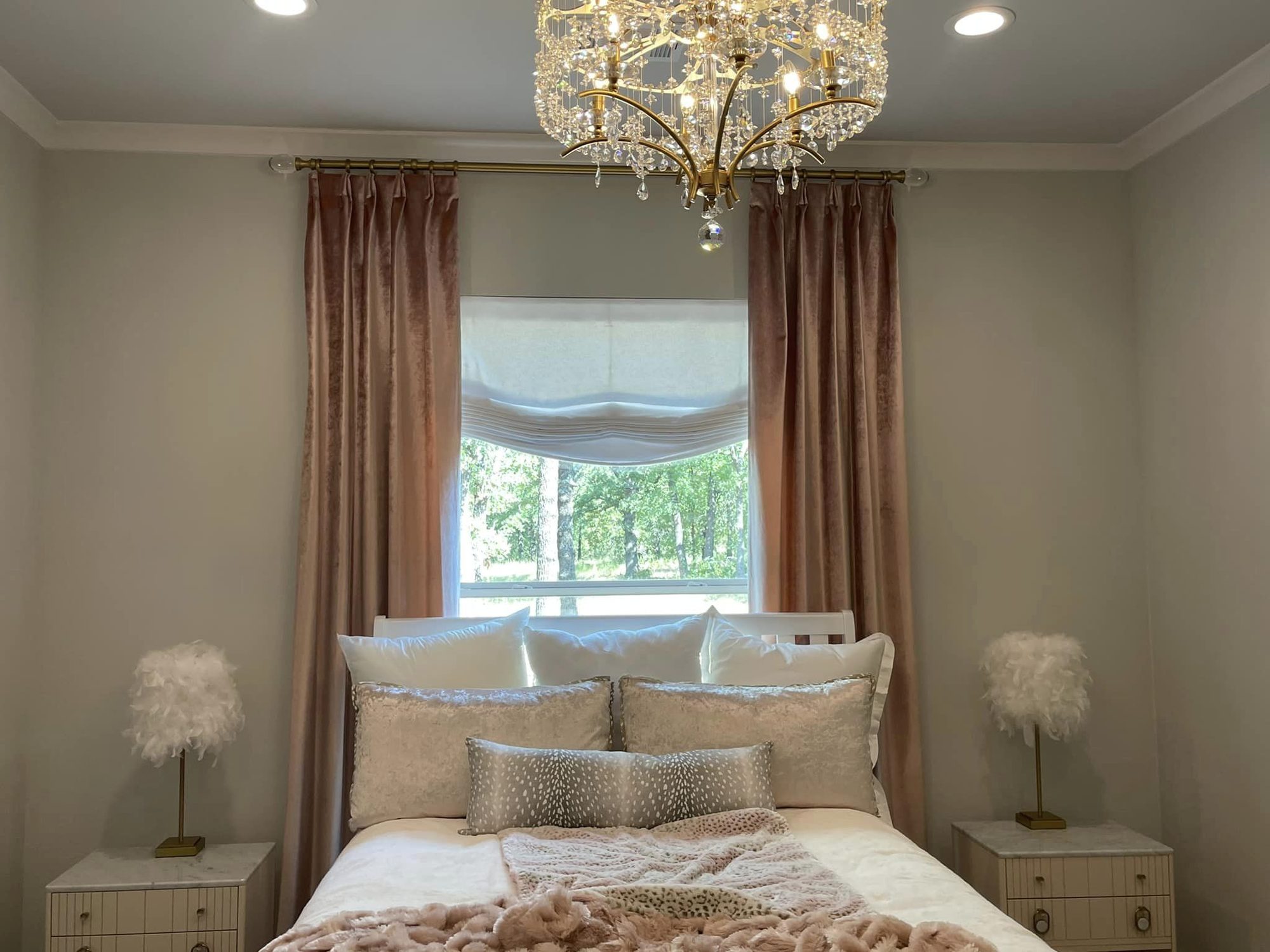 Bedroom with custom drapery and roman shade