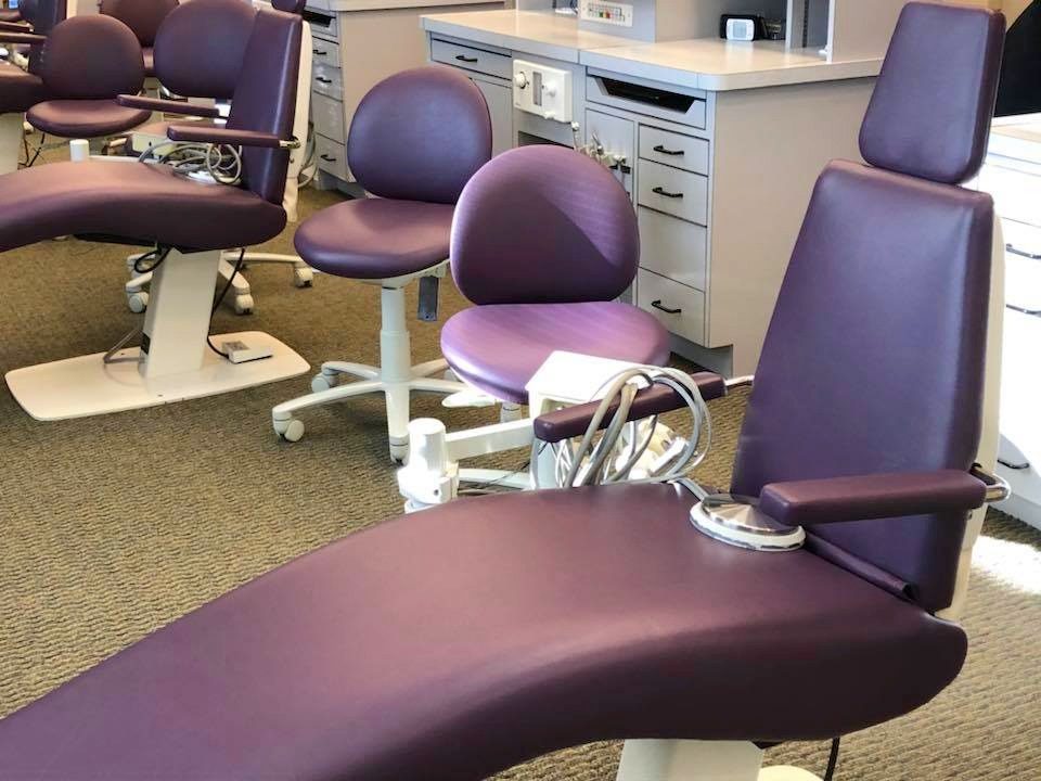 Dental operatory chairs reupholstered in plum vinyl