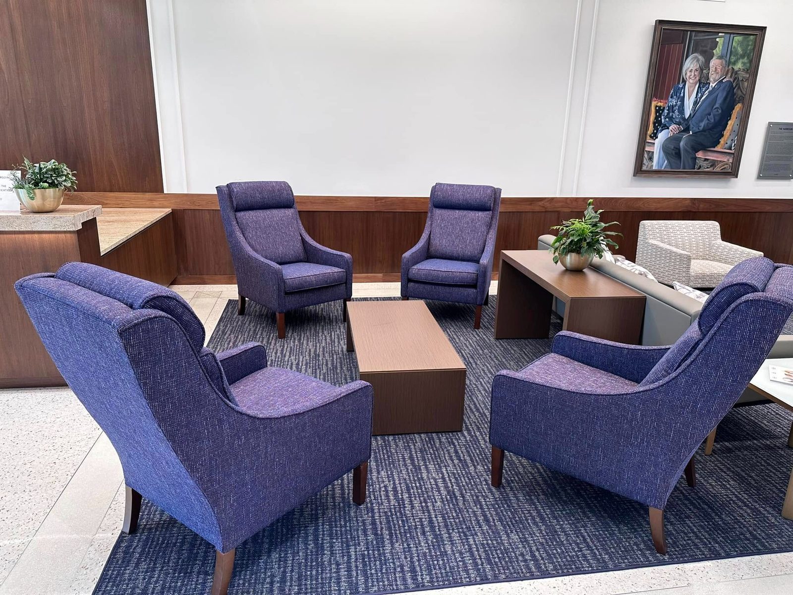 Purple wing chairs in a corporate reception area