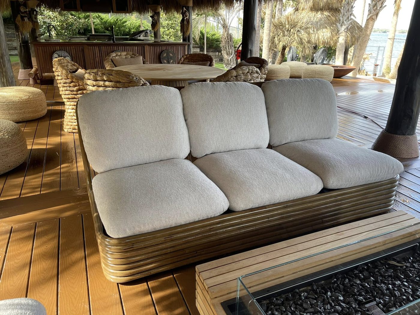 Outdoor sofa with cream cushions on a porch