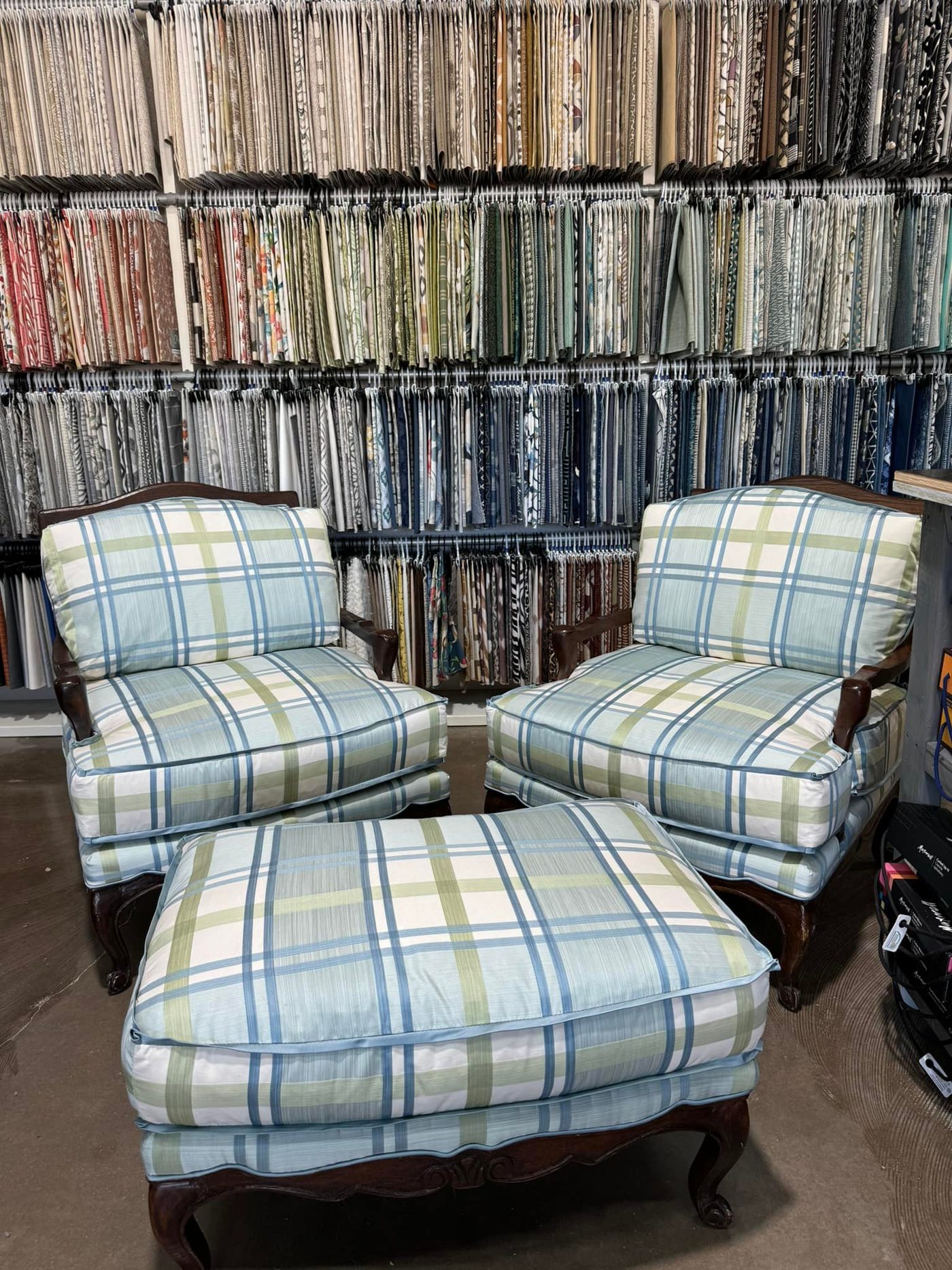 Pair of plaid armchairs with matching ottoman in the showroom