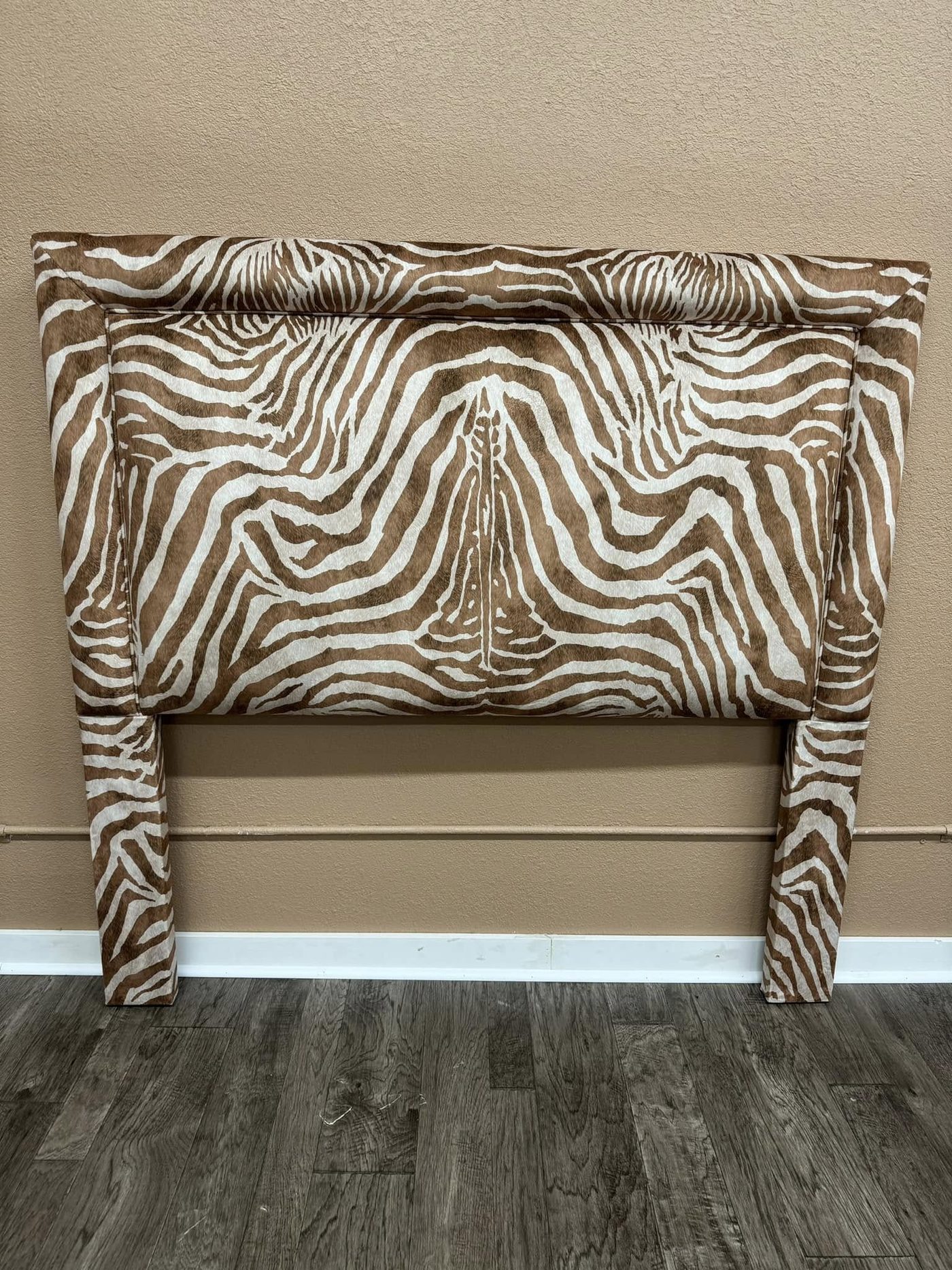 Headboard upholstered in zebra print chenille