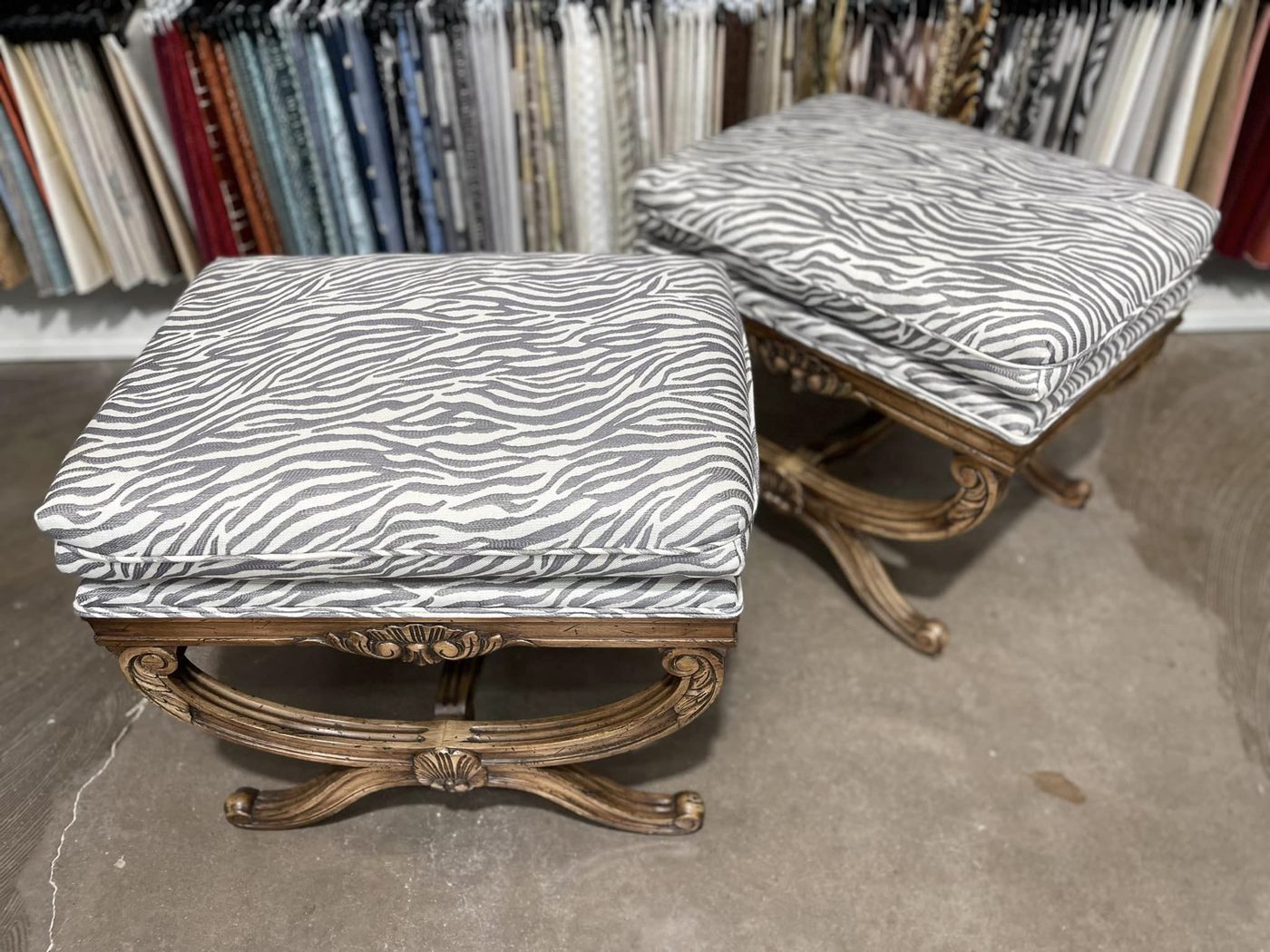 Pair of gilt-frame ottomans in zebra print